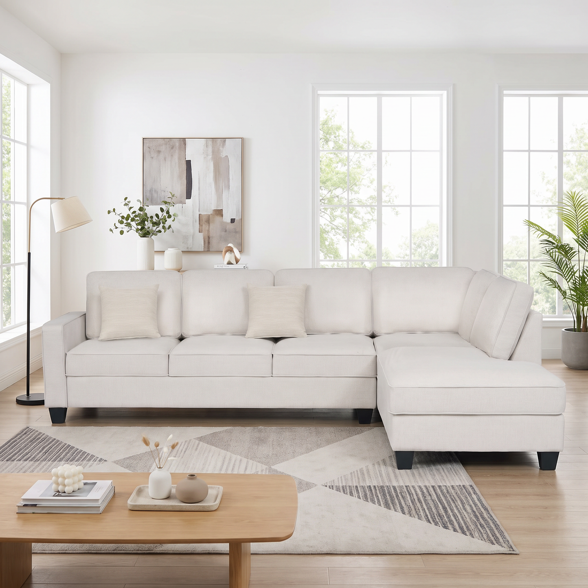 Signature II corner sofa with chaise in beige fabric, chaise on the left when sitting, with two throw cushions, styled in a bright living room