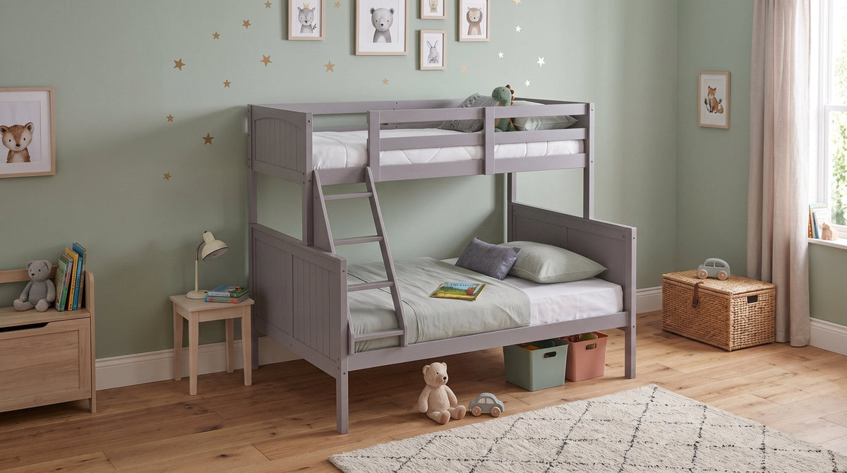 Neves single over double bunk bed in grey timber in a kids bedroom with a small desk and lamp