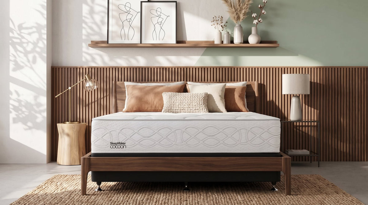 SleepMaker Cocoon Silver Firm mattress on a bed base against a slatted timber wall