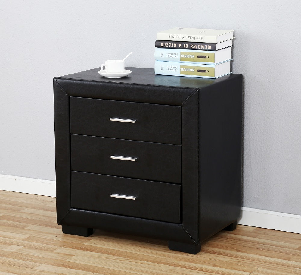 Black bedside table with drawers in a modern bedroom setting. 