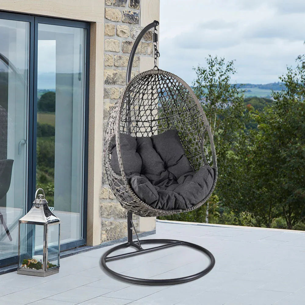 Outdoor swing chair with cushions in modern backyard