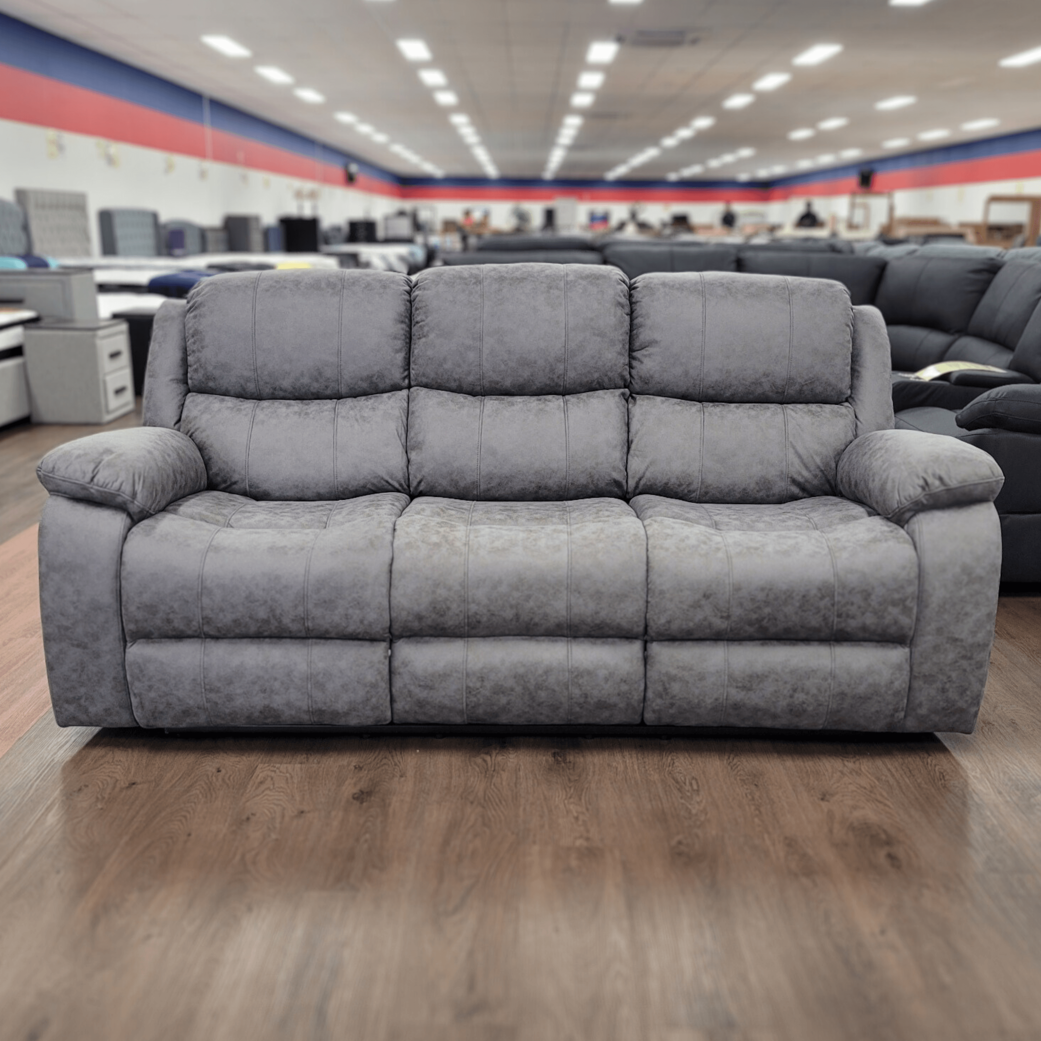 Plush 3 seater recliner lounge in living room with, perfect for relaxing in style.