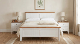 White bed with wooden accents in a bedroom setting
