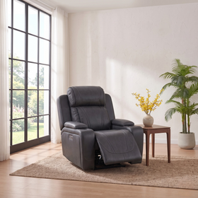 Ballina electric recliner chair in grey leather with the footrest extended, set beside a side table and palm in a bright room - The A2Z Furniture