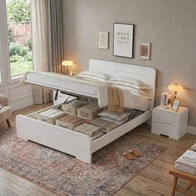 Carinda white gas lift bed with the base raised to show the open under-bed storage filled with labelled boxes and bedding - The A2Z Furniture