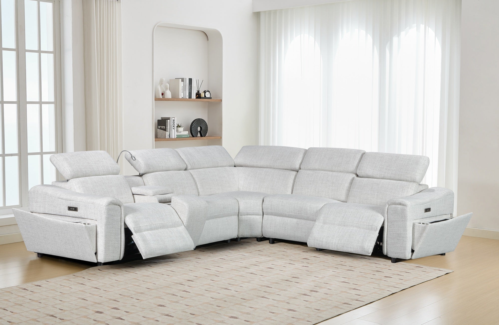 White sectional sofa in a modern living room with large windows.