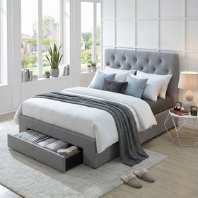 Light Gray upholstered bed with storage drawers in a bright bedroom with large windows.