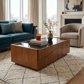 Living room with a wooden coffee table, teal sofa, and beige armchair.