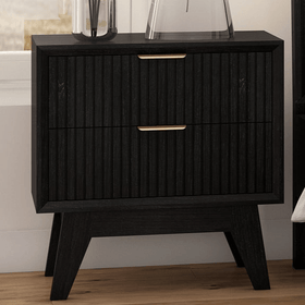 Modern black wooden bedside table with gold handles in a bedroom setting