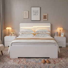 Carinda white gloss gas lift bed, front view with the built-in headboard LED strip lit, curved headboard and footboard, flanked by white bedside tables - The A2Z Furniture