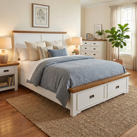 Nursery room with wooden crib, white bedding, and decorative elements.