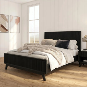 Bedroom with a black bed frame, white bedding, and decorative pillows.