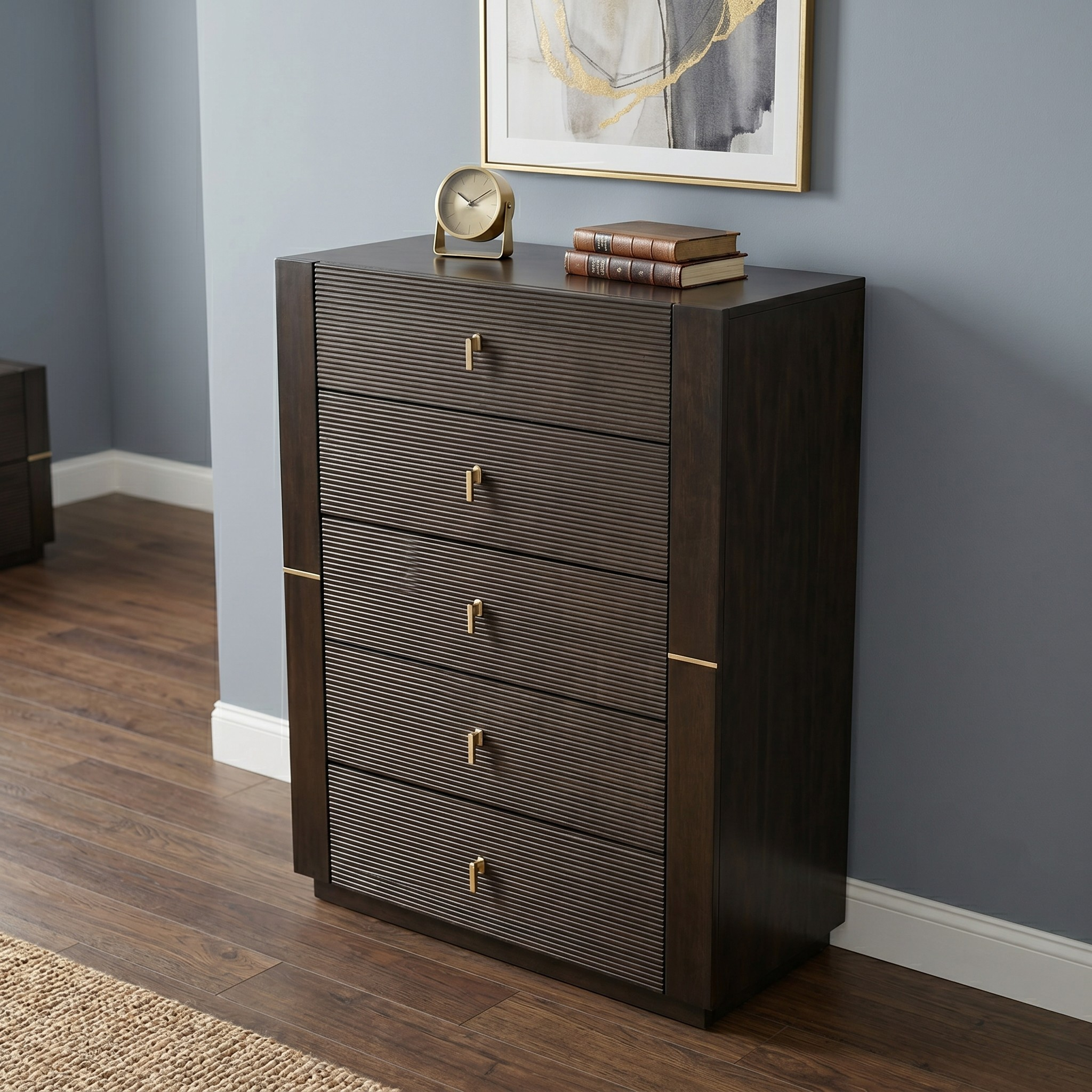 Dark wood dresser with gold accents against a gray wall