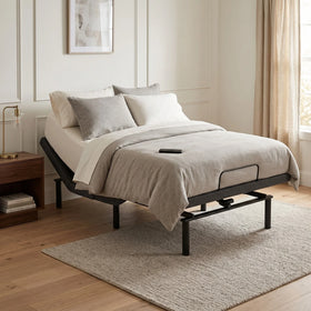 Adjustable Bed base with beige bedding in a bedroom setting