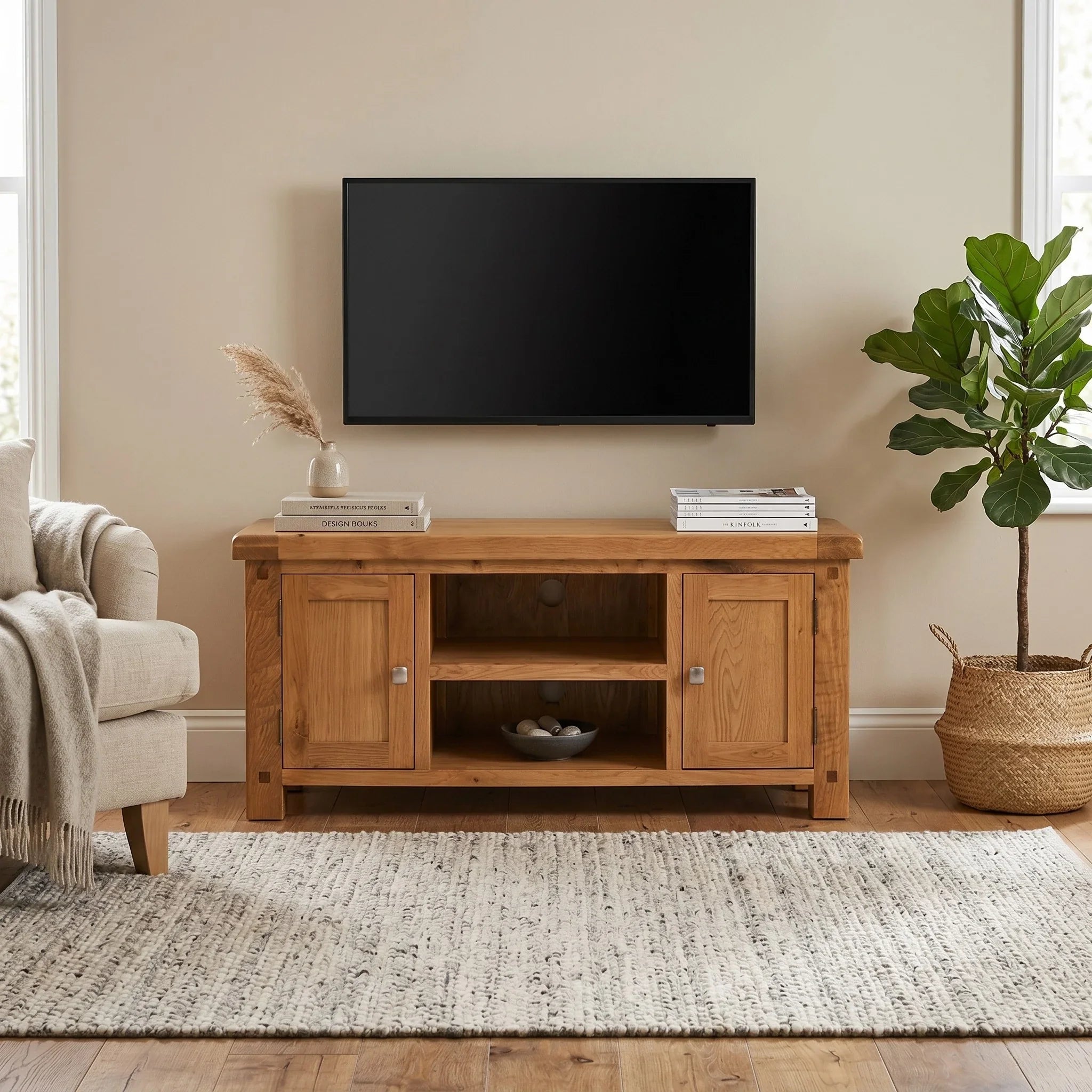 Wooden TV stand with a television mounted on a beige wall in a living room.