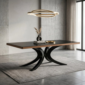 Darkwood Dining Table with rectangular black top, timber edge and sculptural curved black pedestal legs in a modern concrete-walled room - The A2Z Furniture