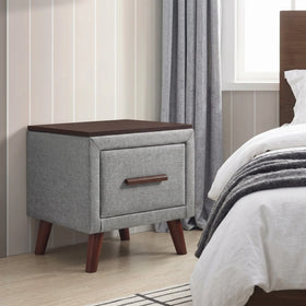 Gray nightstand with wooden top and legs in a bedroom setting
