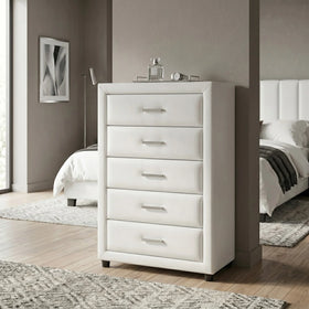 White tallboy in a bedroom setting with a bed and decor in the background