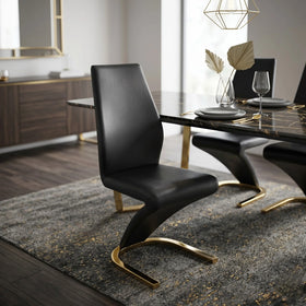 Daisy Chair black PU leather Z-shaped cantilever dining chair on a curved brushed-gold base, beside a marble-top table - The A2Z Furniture