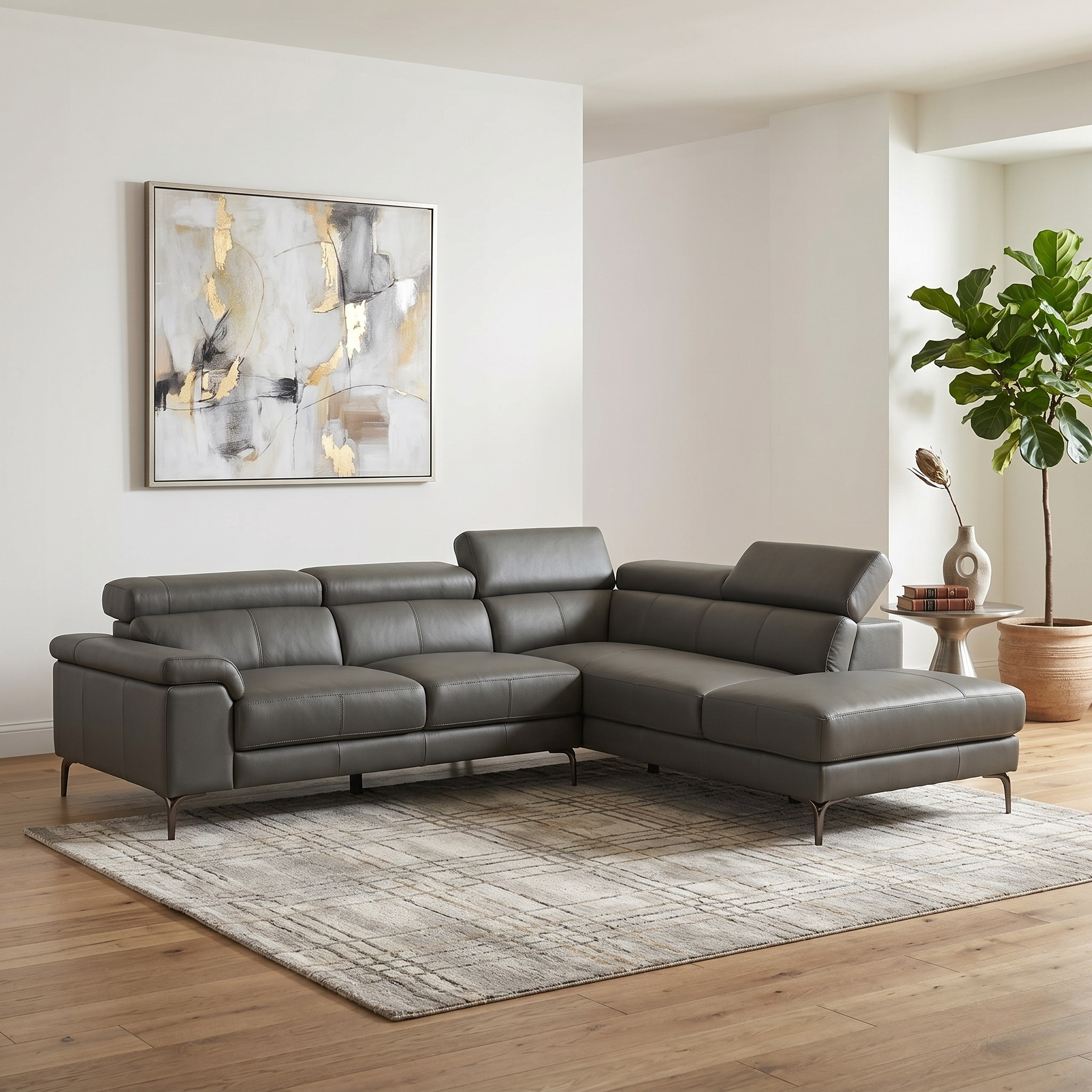Anthracite sectional sofa in a living room with abstract art and a plant.