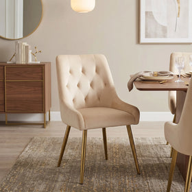 Danna dining chair in cream velvet with a tufted back, padded armrests and tapered gold metal legs, beside a timber dining table - The A2Z Furniture