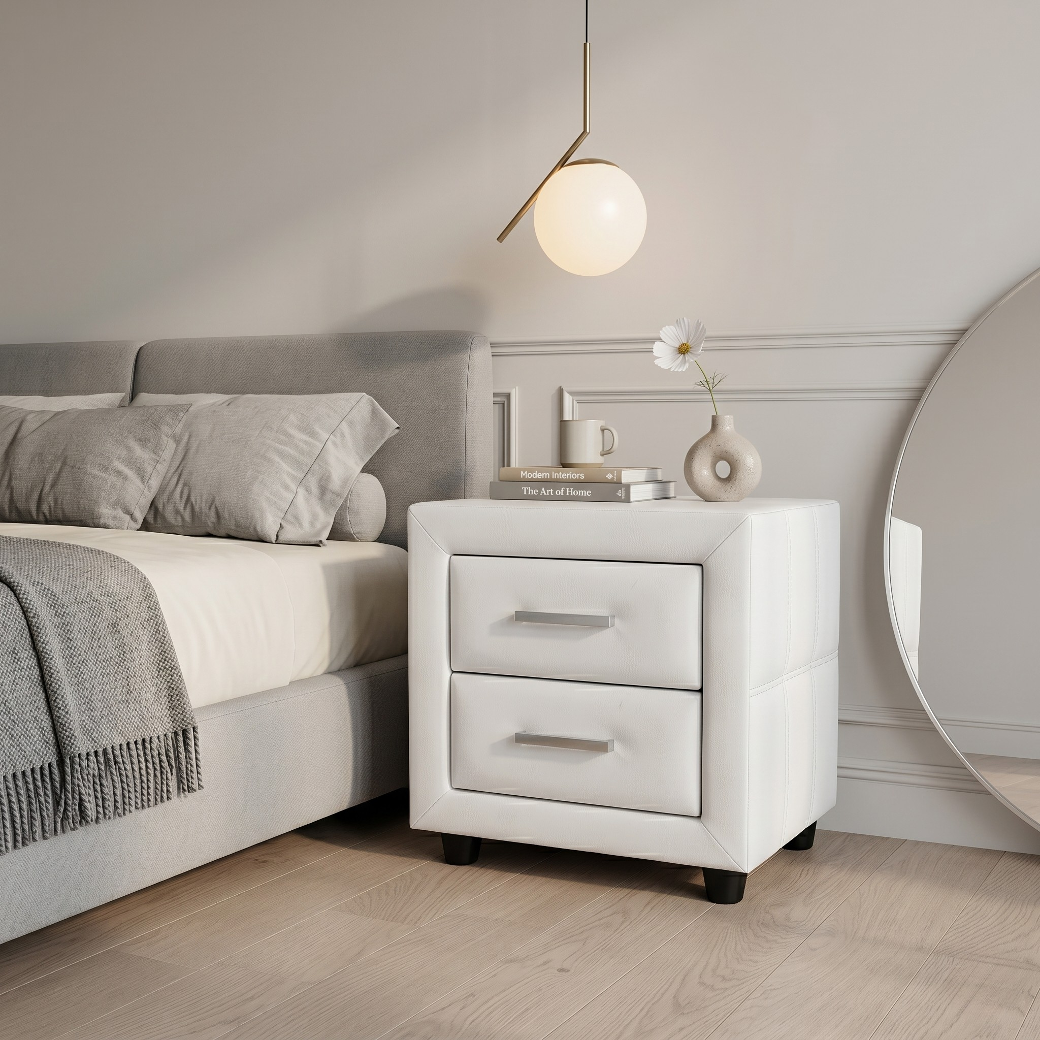 White nightstand with decorative items next to a bed in a bedroom setting.
