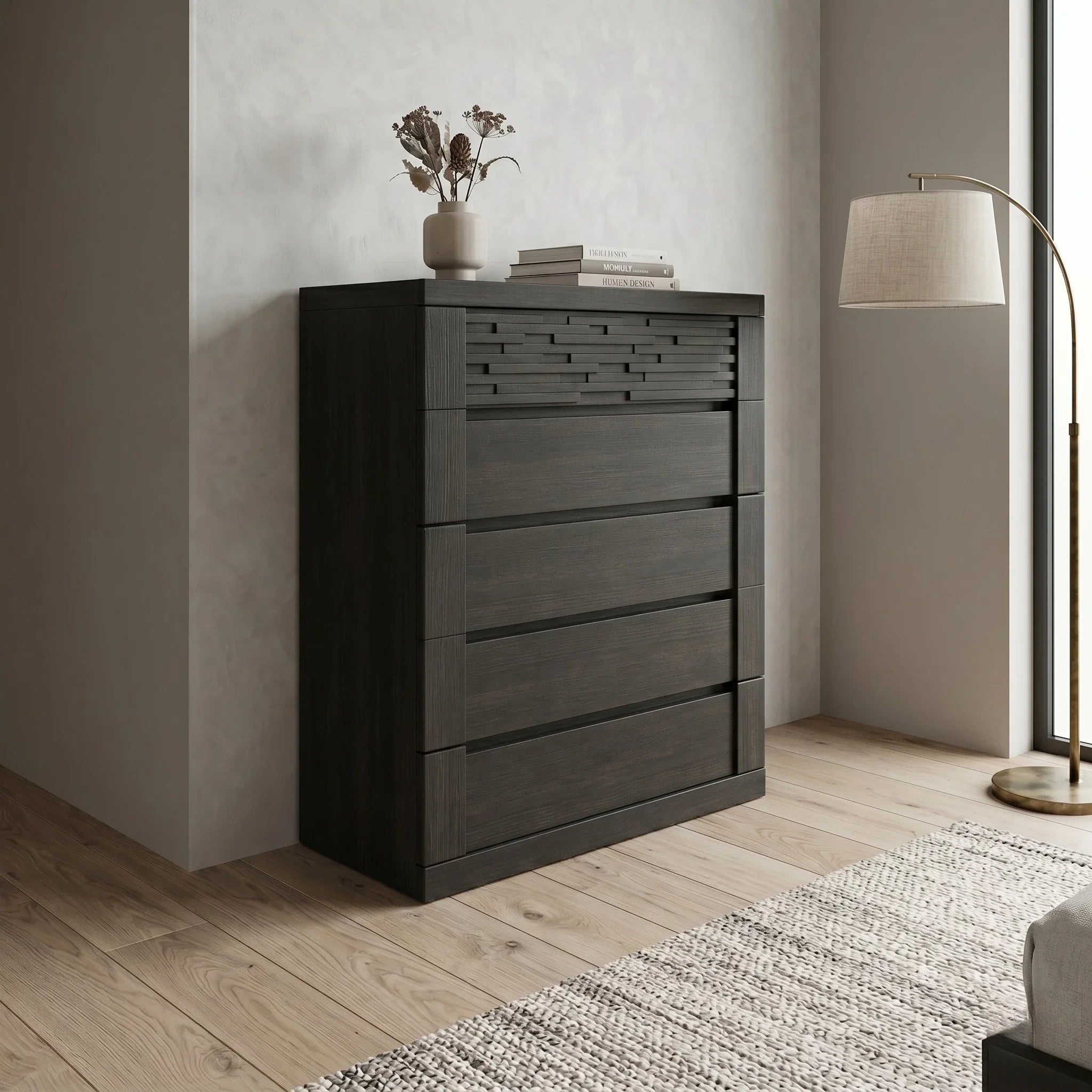 Dark wooden tallboy with five drawers in a room with a lamp and rug.