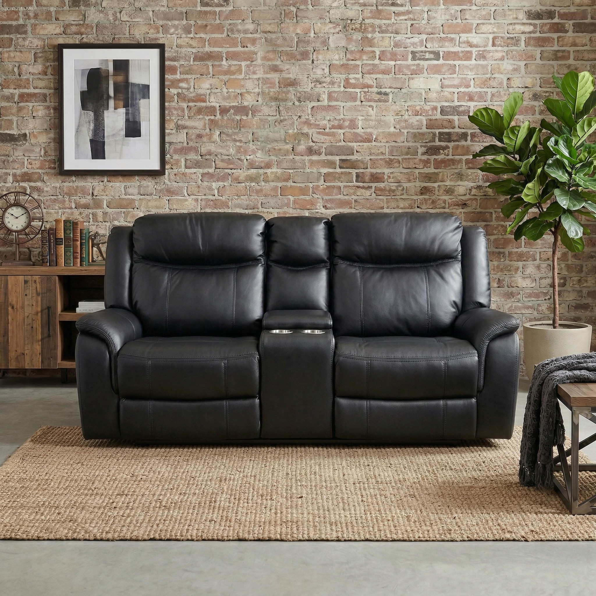 Black leather sofa in a living room with a brick wall and decorative items.