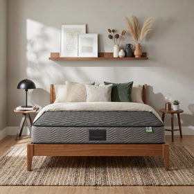 Sleep Essence Bonnell Spring Mattress on a wooden bed frame in a modern bedroom with neutral décor, decorative pillows, side tables, and wall art.