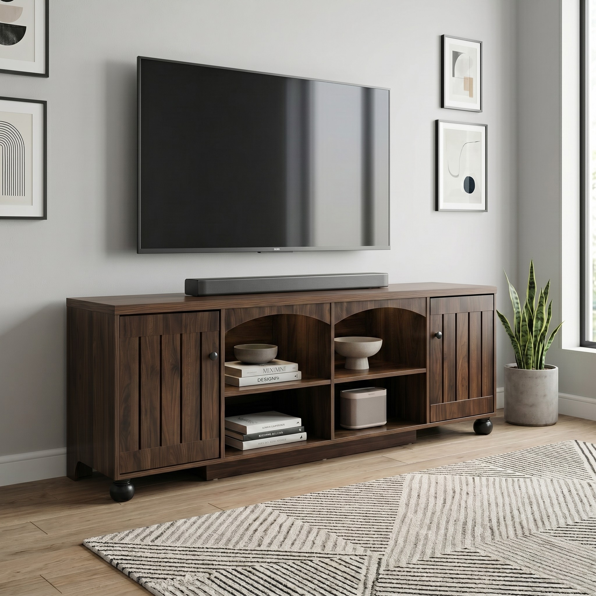 Wooden TV stand with a television and decor items in a living room setting.