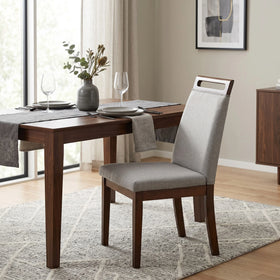 Dalby Dining Chair with grey woven fabric seat and back on a dark walnut-toned timber frame, cut-out handle in the top rail, styled beside a walnut dining table - The A2Z Furniture