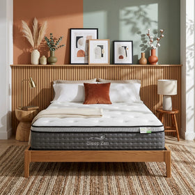 Bed with Sleep Zen mattress in a room with wooden headboard and decorative elements.
