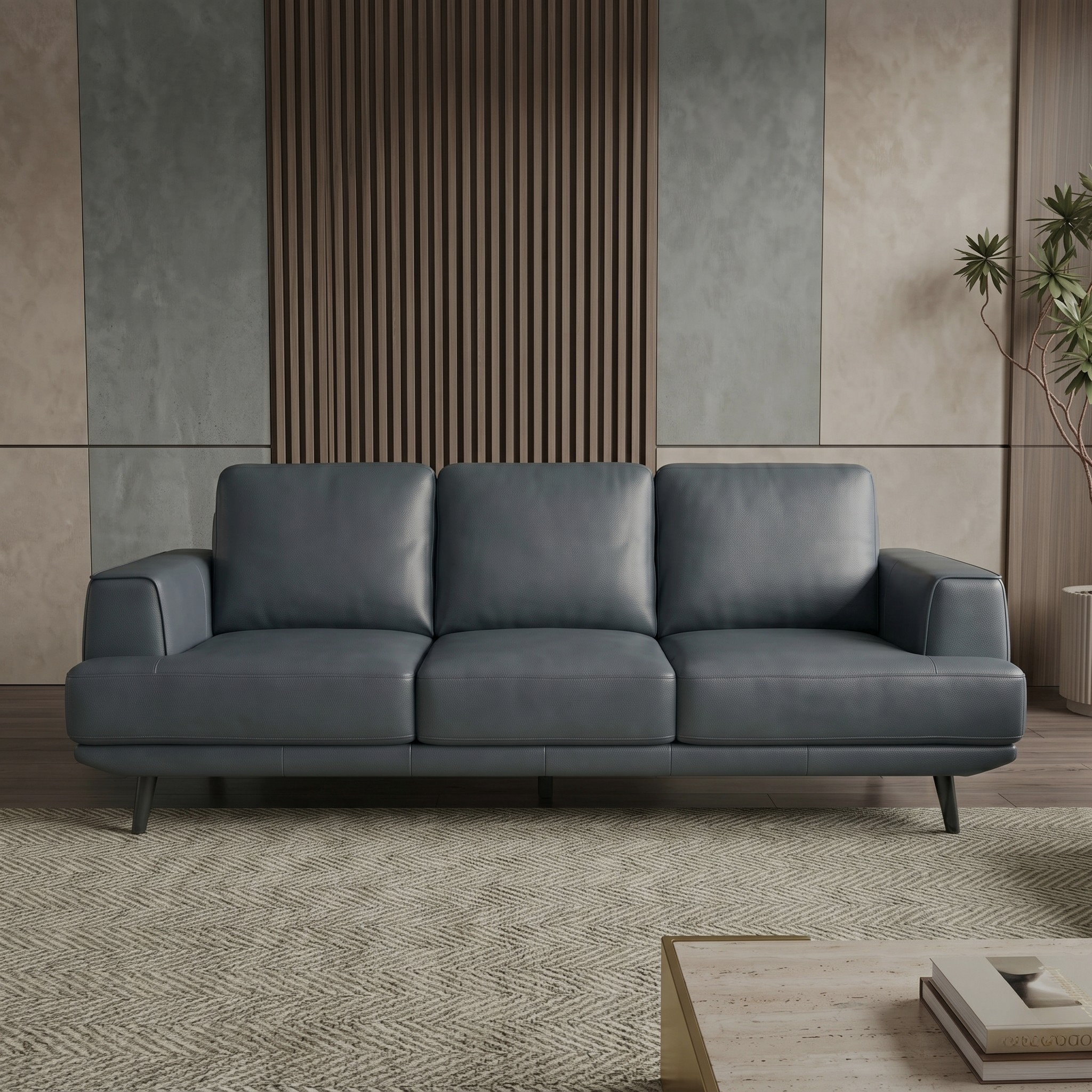 Anthracite leather sofa in a modern living room setting with a neutral color palette.