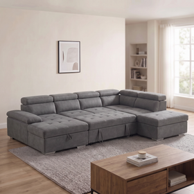 Alex Pull Out Sofa Bed in dark grey fabric with the storage ottoman beside the sofa, adjustable headrests and chaise, in a bright living room