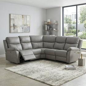 Gray sectional sofa in a living room with a rug and decorative items.