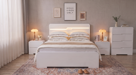 Carinda 4 Piece Tallboy Bedroom Suite in gloss white - gas lift storage bed with lit LED headboard channel, two matching two-drawer bedside tables and a four-drawer tallboy in a warm neutral bedroom - The A2Z Furniture