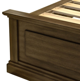 Close-up of wooden bed frame corner with panel detail and slat base
