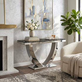 Modern console table with marble top and metal base in a living room setting.