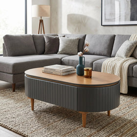 Gray sectional sofa with a wooden coffee table in a living room setting.