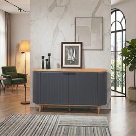 Modern living room with a gray sideboard, green armchair, and decorative elements.