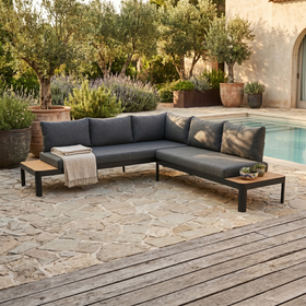 Portals Outdoor Corner Lounge in charcoal with timber side tables and dark grey cushions on a poolside stone patio - The A2Z Furniture