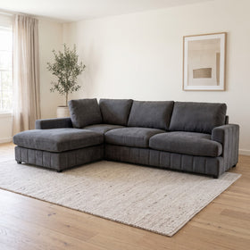 Adore Corner Chaise Lounge in Charcoal with chaise on the right when sitting, deep plush seats and four back cushions, styled in a living room