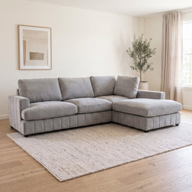 Adore Corner Chaise Lounge in Light Grey with chaise on the left when sitting, deep plush seats and four back cushions, styled in a living room