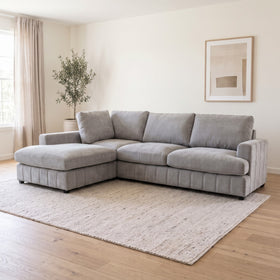 Adore Corner Chaise Lounge in Light Grey with chaise on the right when sitting, deep plush seats and four back cushions, styled in a living room