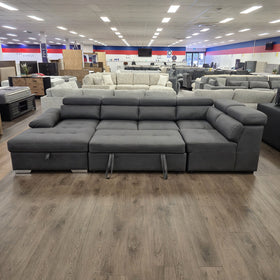 Alex Pull Out Sofa Bed in dark grey fabric, seat partly pulled forward on the pull-out bed mechanism, in The A2Z Furniture showroom