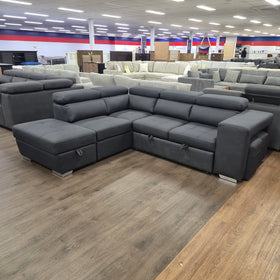 Alice Sofa Bed in black fabric, angled side view showing the full depth of the chaise and ottoman arm, in The A2Z Furniture showroom