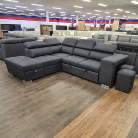 Alice Sofa Bed in black fabric, angled view of the L-shaped lounge with storage chaise and hideaway stools, in The A2Z Furniture showroom