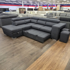 Alice Sofa Bed in black fabric, pulled out flat into the bed with the storage chaise and hideaway stools alongside, in The A2Z Furniture showroom