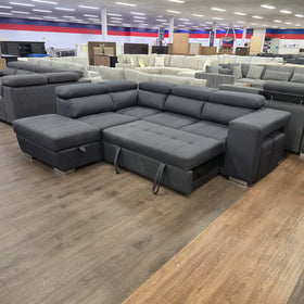 Alice Sofa Bed in black fabric, seat partly pulled forward on the pull-out bed mechanism, in The A2Z Furniture showroom