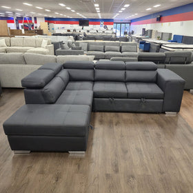 Alice Sofa Bed in black fabric, front-on view with the chaise to the left and adjustable headrests raised, in The A2Z Furniture showroom